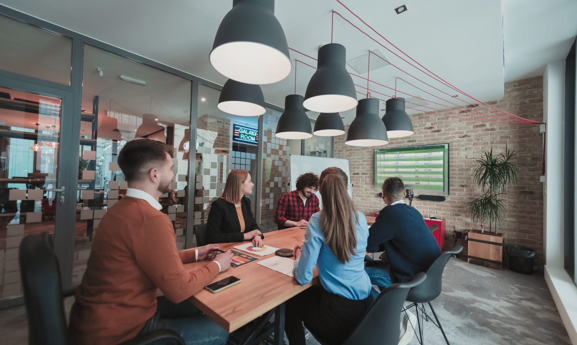Meeting room of team reviewing project plans.
